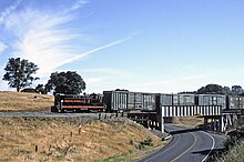Picture of the last freight train to run on the Amador Central Railroad before the line was retired, as it crosses SR 88 near Sunnybrook AF S12 10 with the last outbound June 4 04xRPx - Flickr - drewj1946.jpg
