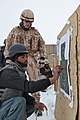 An Afghan Uniformed Police officer places stickers where his rounds hit the target, under the watch of a Czech Military Police instructor, during weapons training on Swanson Small Arms Range at Forward Operating 120201-A-BZ540-008.jpg