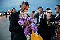 Barack Obama kisses a baby at Denver International Airport, 2012.jpg