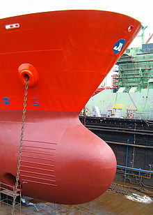 This photo shows the anchor chain running through a ship's hawsepipe Brosen bow ship.jpg