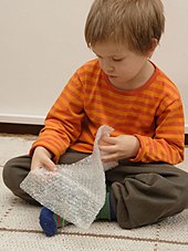 A child playing with bubble wrap Bubble wrap play.jpg