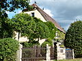 Residential house and section of wall with gate