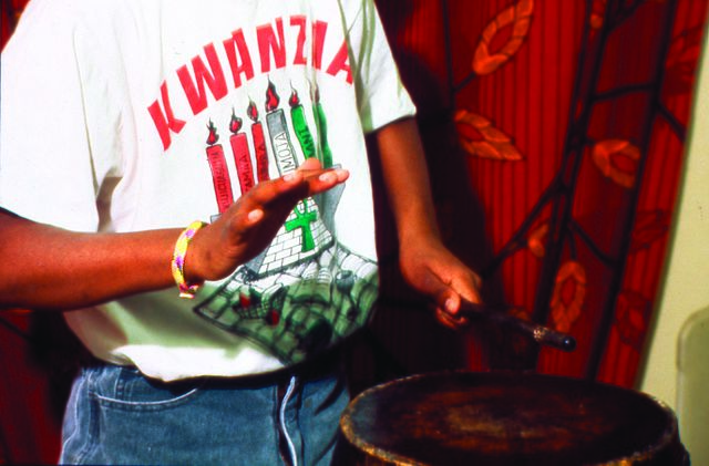 640px-Description-_Young_man_playing_drums_during_Kwanzaa_celebration,_three-quarter_length_portrait._(2536626922).jpg (640×421)