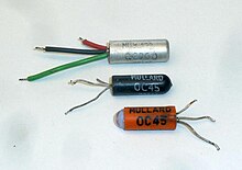 Mullard transistors of the 1960s, showing the variety of SO-2 packages used:
OC200, silicon PNP transistor in an aluminium can.
Germanium OC45 in a black-painted glass package.
OC45 in a clear glass and blue putty package, with rubber sleeve Early Mullard small signal transistor packages.jpg