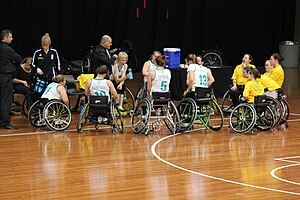 John Triscari (in black shirt and white tie) talks to his national team players. Germany v Australia women's national wheelchair basketball team 5361.jpg