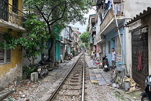 Residences directly adjacent to railway tracks in Hanoi.