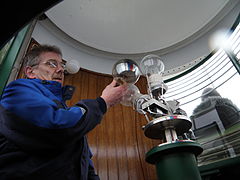 Hans Petur Kjærbo, the lighthouse keeper, is changing the bulbs in the lighthouse in Akraberg.