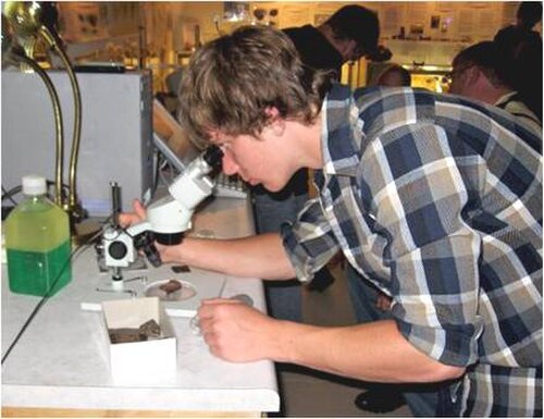 A KAMS student studies meteorites at the Kansas Meteorite Museum.