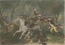 A wounded British officer falls from his horse after being struck by gunfire; another British officer to his rights puts his hands forwards to support the wounded rider; troops skirmish in the background; men lie dead at the riders feet.