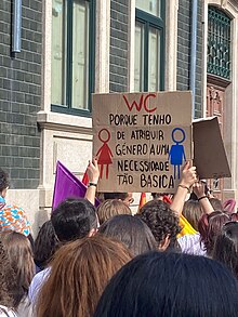 In a card, it reads in portuguese: "Why do I have to assign a gender to such a basic need?". Gender-neutral bathrooms have been a matter of discussion in Portugal. Marcha do Orgulho do Porto WC Neutro.jpg