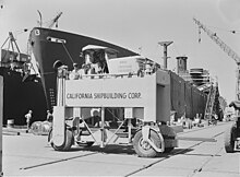 Motorized hoisting truck used in moving scaffolding timbers around the shipyard, 1942. Motorized hoisting truck used in moving scaffolding timbers around the shipyard, California Shipbuilding Corporation, 8d03841.jpg