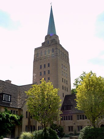 Nuffield College, facing New Road, with the library tower topped by a flèche. The main entrance to the college is in the middle of the building to the left of the tower. The library tower and spire seen from New Road.
