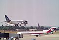 Two planes—one on the tarmac and the other landing