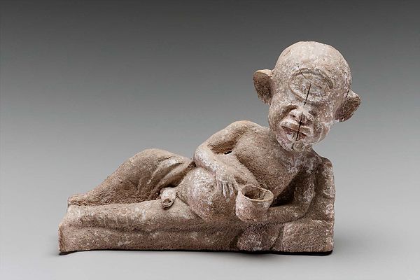 Late Classical terracotta figure depicting Polyphemos reclining while drinking a bowl of wine.