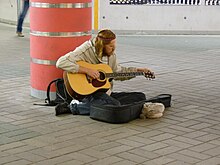 Poor musician asking money for playing.JPG