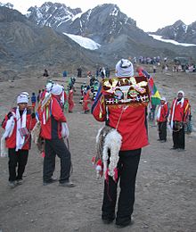 Dancers with the mountains Qullpiqunkpu and Sinaqara behind them. Qoyllur Rit'i dancers.jpg