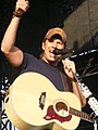 Rodney Atkins with his guitar singing close up.jpg