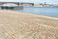 Granite was used for setts on the St. Louis riverfront and for the piers of the Eads Bridge (background)