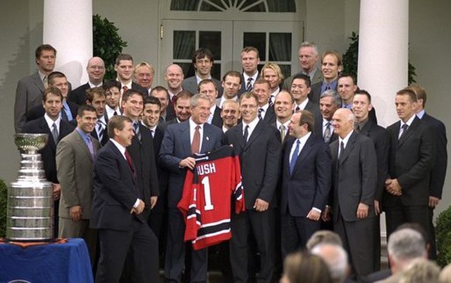 The Devils present President George W. Bush with a jersey after winning the 2003 Stanley Cup championship.