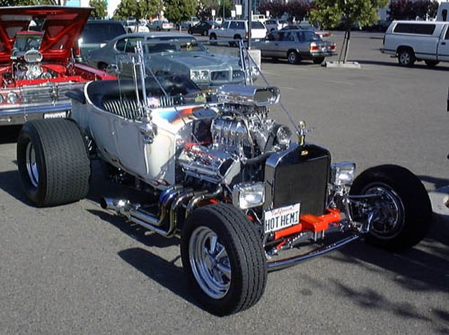 T-bucket with early hemi, but aluminum radiator (rather than brass), rectangular headlights, and five-spokes (rather than motorcycle wheels) mark this