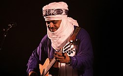 Abdallah Ag Alhousseyni performing with Tinariwen in Vienna during 2011 TINARIWEN Vienna 2011 18.jpg