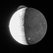 Photo of Io with volcanic eruption plume visible.