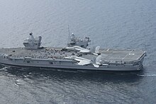 A pair of Super Hornets from USS George H.W. Bush overfly HMS Queen Elizabeth during Exercise Saxon Warrior in 2017