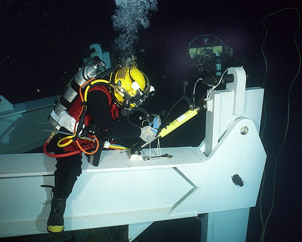 Saturation diver conducts deep sea salvage operations.