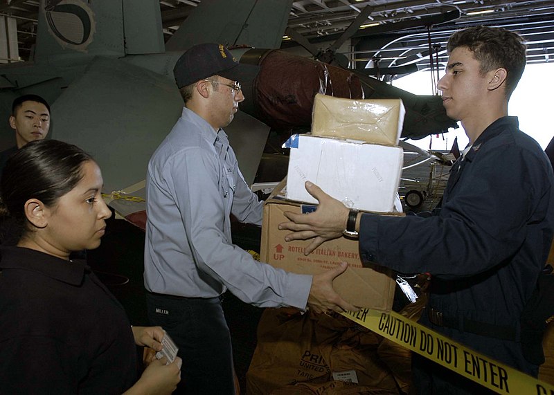 File:US Navy 041209-N-9079D-026 Postal Clerk 3rd Class Brian Pena, center, distributes mail to Sailors in the hangar bay aboard the Nimitz-class aircraft carrier USS Abraham Lincoln (CVN 72).jpg