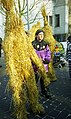 Straw bears in the street in Walldürn (Neckar-Odenwald district, Baden-Württemberg), Germany, with brightly dressed attendants.