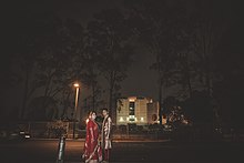 A couple is taking photographs after their wedding ceremony wearing wedding dress in front of the parliament building of Bangladesh Wedding Parliament of Bangladesh.jpg