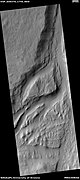 Streamlined feature in Mangala Vallis, as seen by HiRISE under HiWish program. Many dark slope streaks are visible. Location is Memnonia quadrangle.