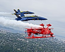 Sean Tucker flying inverted with the US Navy Blue Angels over Seattle 120802-N-DI587-241 (7746606498).jpg