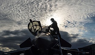 A French Air Force fighter pilot climbs out of a Dassault Rafale after participating in a joint terminal attack controller training scenario during exercise SERPENTEX 16