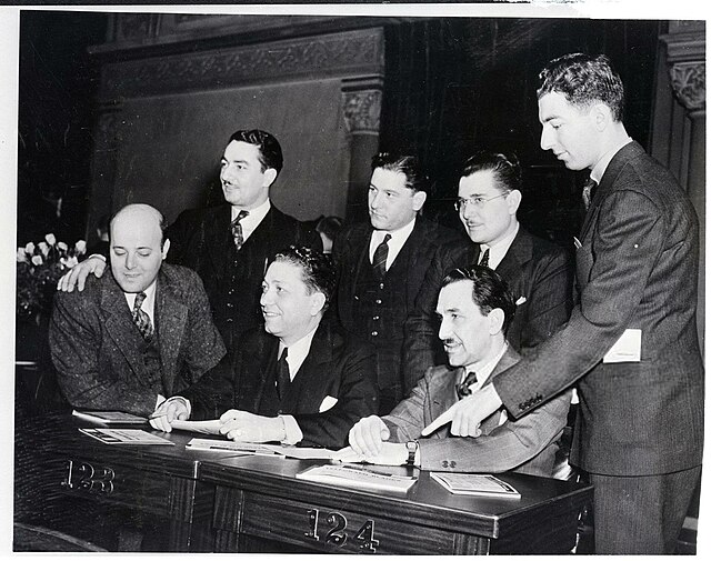 The American Labor Party elected five men to the New York State Assembly in 1937, shown here. Seated (L-R): Frank Monaco, Nathaniel M. Minkoff. Standi