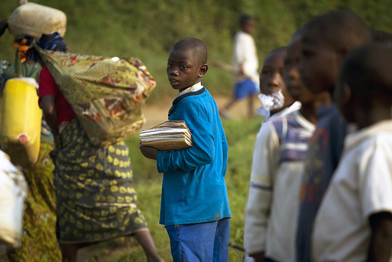 File:A young Congolese boy walks to school close to the refugee camp of Kahe in the town of Kitschoro, in the north eastern part of the Democratic Republic of the Congo.jpg