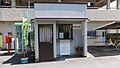 Booth managing the paid bicycle parking shed. The large sign at the top gives the station name and states that JR Shikoku passenger tickets are sold.