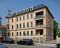 Tenement house with fencing in a corner and open development