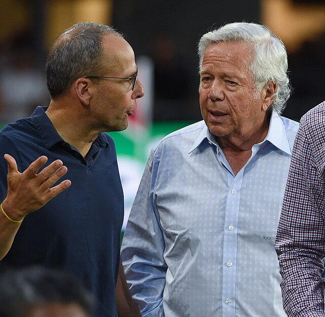 Kraft speaks with his son Jonathan at a 2018 New England Revolution game