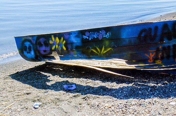 Changes of an abandoned boat on the shore of the lake