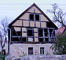 Residential stable house with surrounding wall and courtyard paving