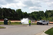 City crew flushing a fire hydrant in Uptown Fayetteville