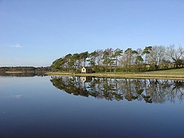 A boat house at the edge of a lake