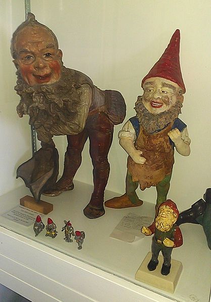 Historic garden gnomes on display at the Gnome Reserve in Devon, UK. The ornament on the left of the image was produced by Eckardt and Mentz in the la