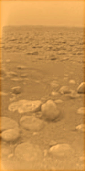 The surface of Titan as viewed from the Huygens lander. Tholins, complex particles formed by UV irradiation on the N2 and CH4 atmosphere, are likely t