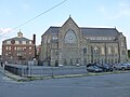 Immaculate Conception Church, a Roman Catholic Church located at 144 East Merrimack Street, Lowell, Massachusetts. West side of buildings shown.