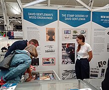 Inspecting a collection of David Gentleman woodblock designs at The Postal Museum stand at London 2022 International Stamp Exhibition Inspecting a collection of David Gentleman woodblock designs.jpg