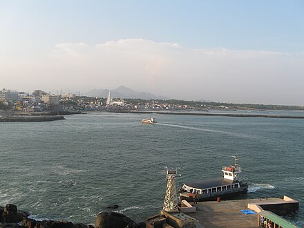 The ferries transporting tourists from the mainland to the islands can be seen with one returning to the mainland and the other one about to stop at the Tiruvalluvar statue after carrying over tourists from Vivekananda Rock.