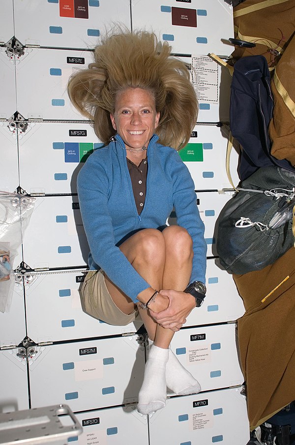 Karen Nyberg weightless on the middeck of Discovery while docked with the ISS