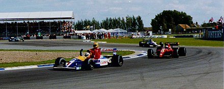 1991 British Grand Prix winner Nigel Mansell giving Ayrton Senna a lift back to the Silverstone paddock after Senna had run out of fuel